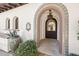 Close up of a home's entrance with colorful tile work around the door at 4949 E Lincoln Dr # 11, Paradise Valley, AZ 85253