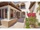 Gorgeous exterior detail with colorful tile accents, an arched balcony, and lush landscaping around the property at 4949 E Lincoln Dr # 11, Paradise Valley, AZ 85253
