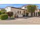 An inviting property displaying lush landscaping with a warm, stucco exterior and brick driveway at 4949 E Lincoln Dr # 11, Paradise Valley, AZ 85253