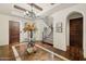 Grand foyer showcasing a beautiful staircase, chandelier, and custom flooring leading to an arched doorway at 4949 E Lincoln Dr # 11, Paradise Valley, AZ 85253