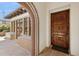 Elegant entrance featuring decorative tile work, a covered bench seat, and a dark wood door at 4949 E Lincoln Dr # 11, Paradise Valley, AZ 85253