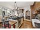 Kitchen featuring dark wood cabinets, stainless steel appliances, decorative backsplash, and a central island with barstool seating at 4949 E Lincoln Dr # 11, Paradise Valley, AZ 85253
