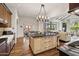 Kitchen featuring a center island with seating and stainless appliances, dark wood cabinets and hardwood floors at 4949 E Lincoln Dr # 11, Paradise Valley, AZ 85253