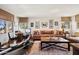 Spacious living room with comfortable seating, custom lighting, and a partial view of the exercise equipment at 4949 E Lincoln Dr # 11, Paradise Valley, AZ 85253
