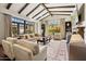 A spacious living room features a beamed ceiling, comfortable seating, a stone fireplace, and large windows with natural light at 4949 E Lincoln Dr # 11, Paradise Valley, AZ 85253