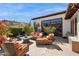 Spacious patio has plenty of seating, an outdoor fireplace, and lush landscaping at 4949 E Lincoln Dr # 11, Paradise Valley, AZ 85253
