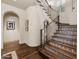 Elegant staircase with decorative tile risers, dark wood railings, and a hardwood landing at 4949 E Lincoln Dr # 11, Paradise Valley, AZ 85253