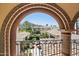 Beautiful view of the neighborhood and mountains beyond is framed by the archway at 4949 E Lincoln Dr # 11, Paradise Valley, AZ 85253