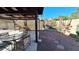 Charming backyard featuring a covered patio, desert landscaping, and a privacy fence at 5002 W Christy Dr, Glendale, AZ 85304
