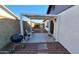 Backyard showcasing a covered patio area with a grill, seating, and desert landscaping at 5002 W Christy Dr, Glendale, AZ 85304