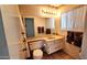 Bathroom with a light countertop sink, decorative towels, and wallpaper at 5002 W Christy Dr, Glendale, AZ 85304