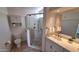 Bathroom featuring glass shower, tiled floor, and double sink vanity at 5002 W Christy Dr, Glendale, AZ 85304