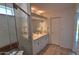 Bathroom featuring glass shower, tiled floor, and double sink vanity at 5002 W Christy Dr, Glendale, AZ 85304