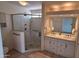 Bathroom featuring glass shower, tiled floor, and double sink vanity at 5002 W Christy Dr, Glendale, AZ 85304