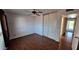 Bedroom featuring wood floors, a ceiling fan, and closet with sliding doors at 5002 W Christy Dr, Glendale, AZ 85304