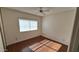 Bedroom with wood floors and large window with horizontal blinds at 5002 W Christy Dr, Glendale, AZ 85304