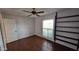 Bedroom with hardwood floors, a window, built in shelves and a closet at 5002 W Christy Dr, Glendale, AZ 85304