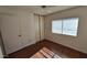Bedroom with wood floors, a large window, and closet at 5002 W Christy Dr, Glendale, AZ 85304