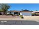 Charming single-story home with a two-car garage, desert landscaping, and a well-maintained lawn at 5002 W Christy Dr, Glendale, AZ 85304