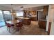 Spacious kitchen features granite counters, an island, stainless appliances, and access to the backyard at 5002 W Christy Dr, Glendale, AZ 85304