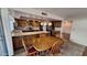 Bright kitchen featuring granite countertops, wooden cabinets, tile floor, and a four-chair dining table at 5002 W Christy Dr, Glendale, AZ 85304