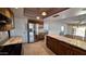 Open kitchen with granite countertops, stainless steel appliances, and adjacent dining space at 5002 W Christy Dr, Glendale, AZ 85304