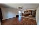 Living room with wood flooring and tile floor in kitchen with a ceiling fan at 5002 W Christy Dr, Glendale, AZ 85304
