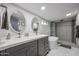 Stylish bathroom featuring dual sinks, modern fixtures, and a luxurious soaking tub and shower at 519 E El Camino Dr, Phoenix, AZ 85020