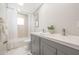 Bright bathroom featuring a dual sink vanity and decorative shower at 519 E El Camino Dr, Phoenix, AZ 85020