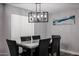 Inviting dining area featuring a stylish light fixture, dining table with seating for six, and neutral decor at 519 E El Camino Dr, Phoenix, AZ 85020