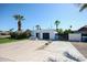 Modern home featuring a two-car garage, complemented by lush desert landscaping and clear blue skies at 519 E El Camino Dr, Phoenix, AZ 85020
