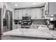 Well-equipped with stainless steel appliances, ample counter space, and custom cabinetry for organization at 519 E El Camino Dr, Phoenix, AZ 85020