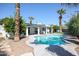 Refreshing pool with a spacious patio area, surrounded by lush landscaping and palm trees at 519 E El Camino Dr, Phoenix, AZ 85020