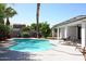 Sparkling backyard pool with mature landscaping and a covered patio at 519 E El Camino Dr, Phoenix, AZ 85020