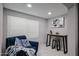 Bright sitting room featuring a cozy blue chair, accent table, and neutral decor at 519 E El Camino Dr, Phoenix, AZ 85020
