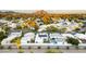 Scenic aerial view of a modern community with vibrant greenery, white houses, and picturesque mountain backdrop at 5318 N 24Th Pl, Phoenix, AZ 85016