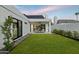 A serene backyard with lush lawn, covered patio, elegant outdoor furniture, and modern design at 5318 N 24Th Pl, Phoenix, AZ 85016