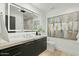 Stylish bathroom with backlit mirror, marble countertop, and sleek vanity at 5318 N 24Th Pl, Phoenix, AZ 85016