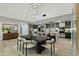 Open-concept dining area with modern chandelier, adjacent to a gourmet kitchen featuring sleek countertops and bar seating at 5318 N 24Th Pl, Phoenix, AZ 85016