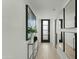 Bright hallway with modern art, mirrored accents, and stylish front door, creating an inviting and contemporary entrance at 5318 N 24Th Pl, Phoenix, AZ 85016