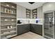 Contemporary kitchen features modern shelving, stainless steel appliances and a built-in wine cooler, adding luxury at 5318 N 24Th Pl, Phoenix, AZ 85016