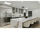 Modern kitchen with waterfall island, sleek cabinetry, stainless steel appliances, and bar seating, perfect for entertaining at 5318 N 24Th Pl, Phoenix, AZ 85016