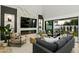 Comfortable living room with dark gray couch and an open transition to an outdoor patio at 5318 N 24Th Pl, Phoenix, AZ 85016