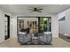 Covered patio offering comfortable seating, a ceiling fan, and a view into the home's interior at 5318 N 24Th Pl, Phoenix, AZ 85016