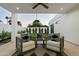 Inviting covered patio with cozy armchairs, decorative pillows, and a view of the landscaped backyard at 5318 N 24Th Pl, Phoenix, AZ 85016