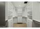 Spacious walk-in closet featuring custom shelving, drawers, and ample storage space for clothes and accessories at 5318 N 24Th Pl, Phoenix, AZ 85016