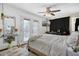 Bright bedroom with backyard access, ceiling fan, and large television at 5407 W Cambridge Ave, Phoenix, AZ 85035