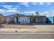 Street view of the home with a front carport, minimal landscaping, and sidewalk at 5407 W Cambridge Ave, Phoenix, AZ 85035