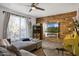 Modern living room with wood accent wall, sleek fireplace, and large windows for natural light at 5407 W Cambridge Ave, Phoenix, AZ 85035