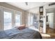 Sun-filled main bedroom featuring a patterned sliding closet door and a door to the backyard at 5407 W Cambridge Ave, Phoenix, AZ 85035